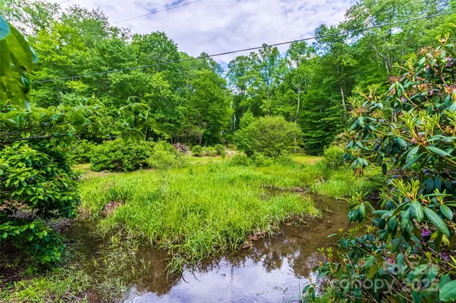 a backyard of a house with a yard and outdoor seating