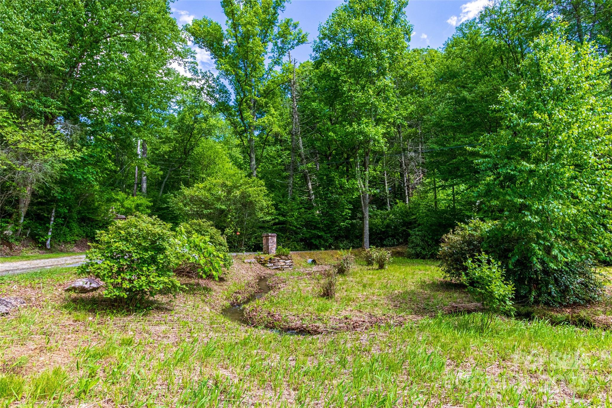 Tbd Memory Lane Cullowhee, NC 28723 - Photo 37 of 41 a backyard of a house with a yard and outdoor seating