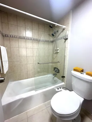 a bathroom with a toilet bathtub and shower