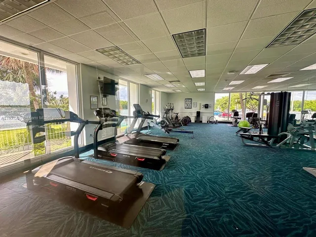 a room with lots of pool table and a large window