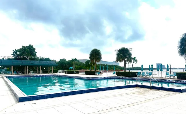 a view of swimming pool with outdoor seating and yard in back