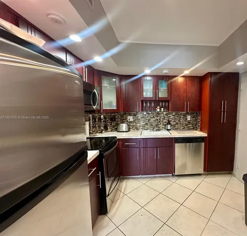 a kitchen with a sink and wooden cabinets