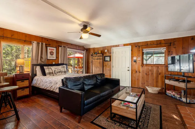 a living room with furniture fireplace and wooden floor