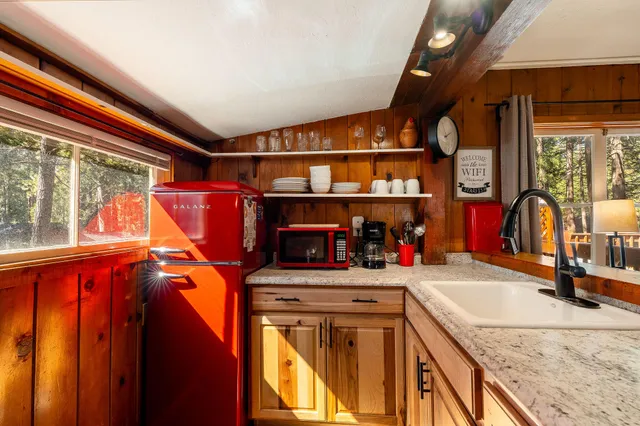 a kitchen with stainless steel appliances granite countertop a sink and cabinets