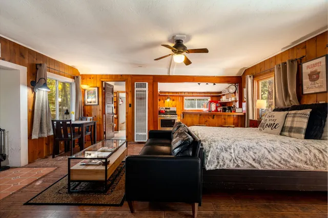 a bedroom with a bed and wooden floor