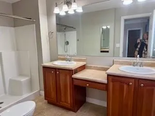 a bathroom with a sink double vanity and a mirror