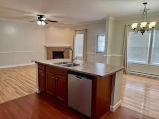 an open kitchen with a sink and a fireplace