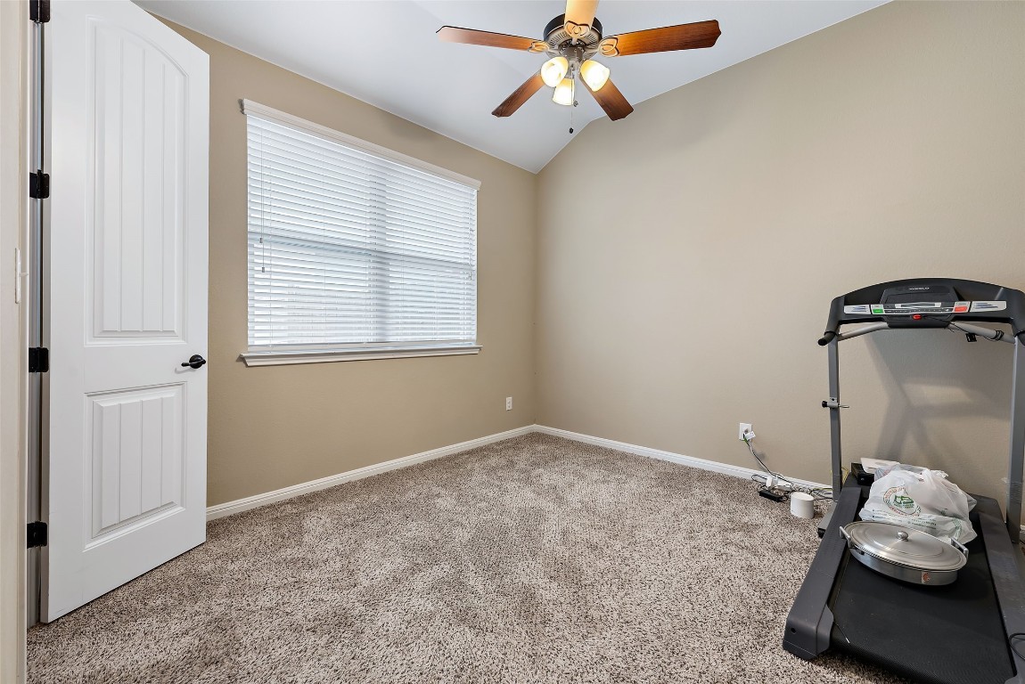 2000 Manada Trail Leander, TX 78641 - Photo 27 of 36 A versatile room featuring vaulted ceilings and soft carpeting, ideal for an office or guest space.