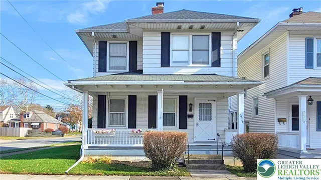 a view of a house with a porch and furniture