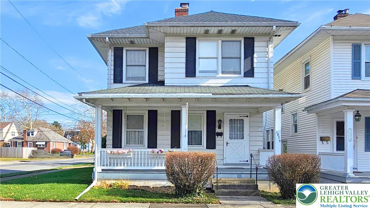 a view of a house with a porch and furniture
