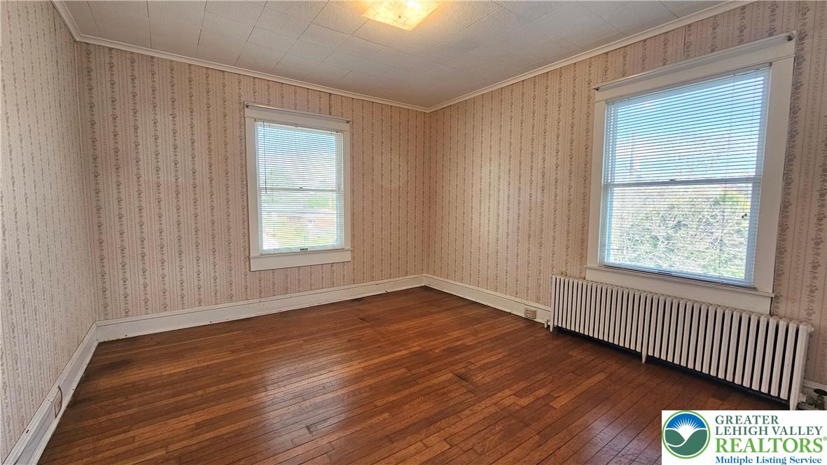 1936 Kemmerer Street Bethlehem, PA 18017 - Photo 17 of 27 an empty room with wooden floor and windows