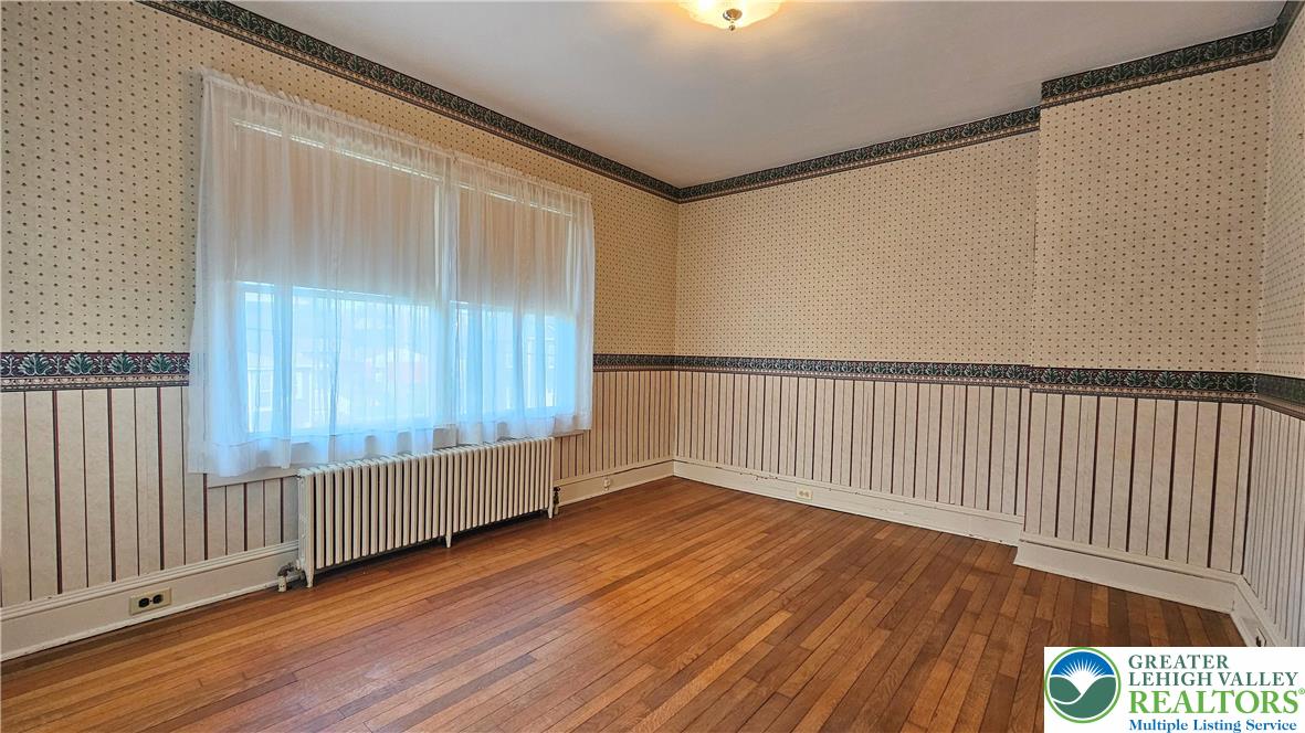 1936 Kemmerer Street Bethlehem, PA 18017 - Photo 20 of 27 a view of an empty room with wooden floor and a window