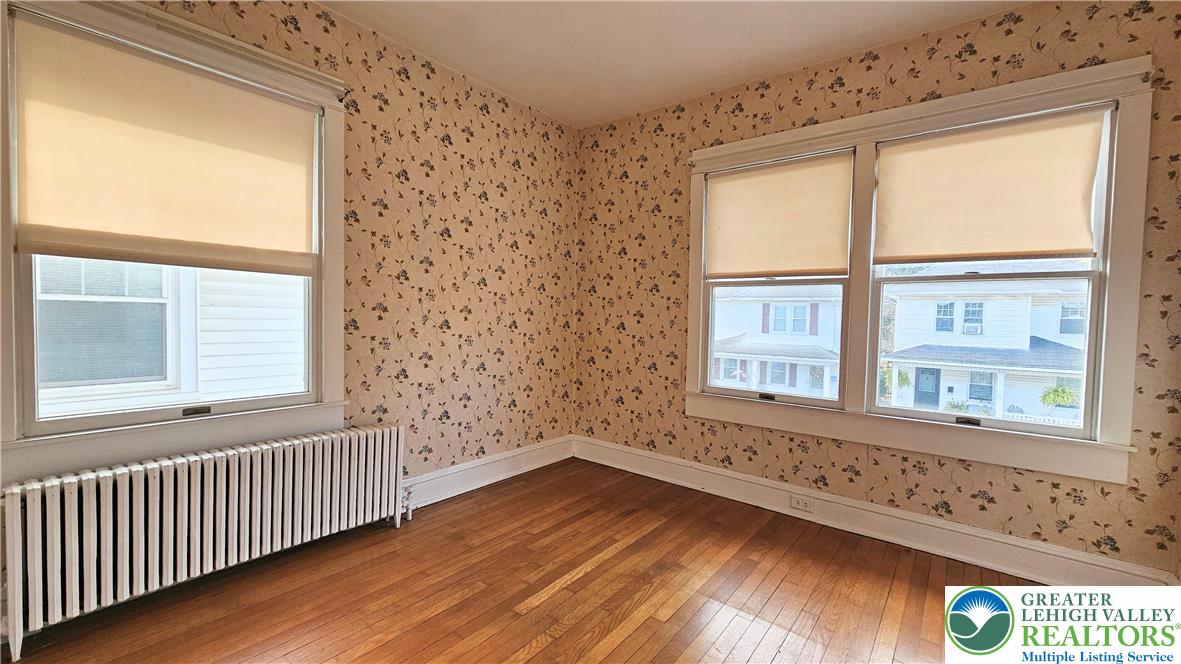 1936 Kemmerer Street Bethlehem, PA 18017 - Photo 21 of 27 a view of an empty room with wooden floor and a window