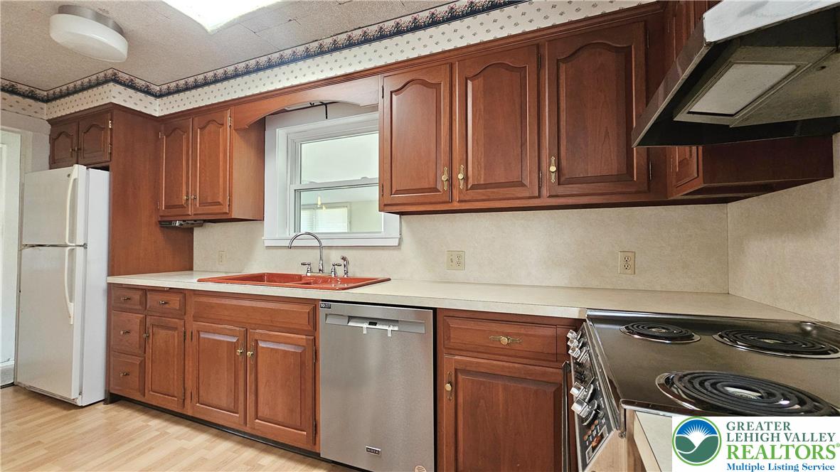 1936 Kemmerer Street Bethlehem, PA 18017 - Photo 9 of 27 a kitchen with a stove and a refrigerator
