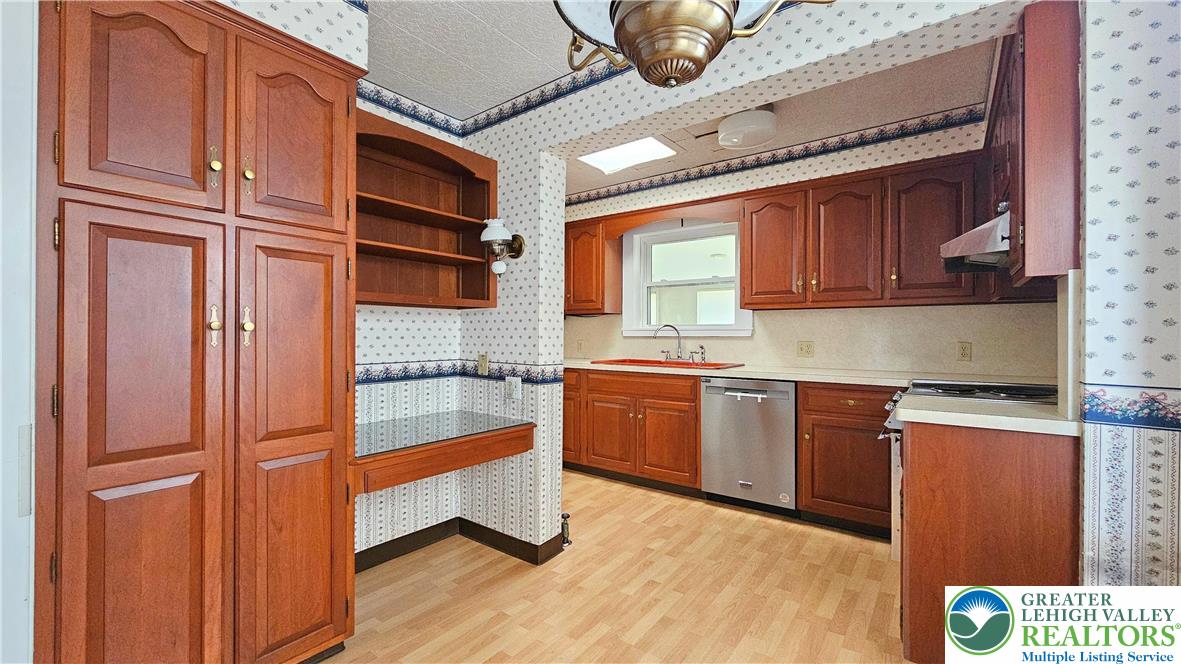 1936 Kemmerer Street Bethlehem, PA 18017 - Photo 10 of 27 a kitchen with granite countertop stainless steel appliances and wooden cabinets