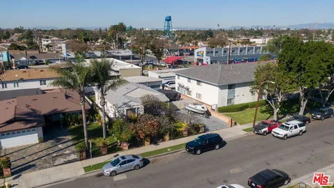a city street filled with lots of traffic and parked cars