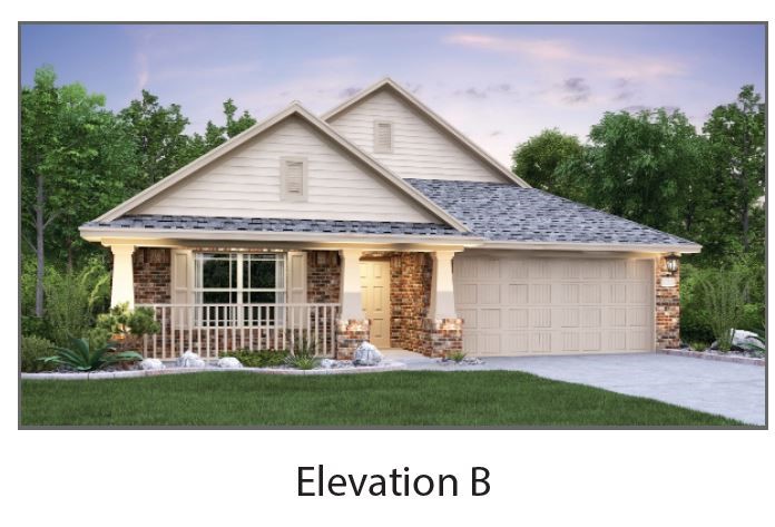 a front view of a house with a garden and yard