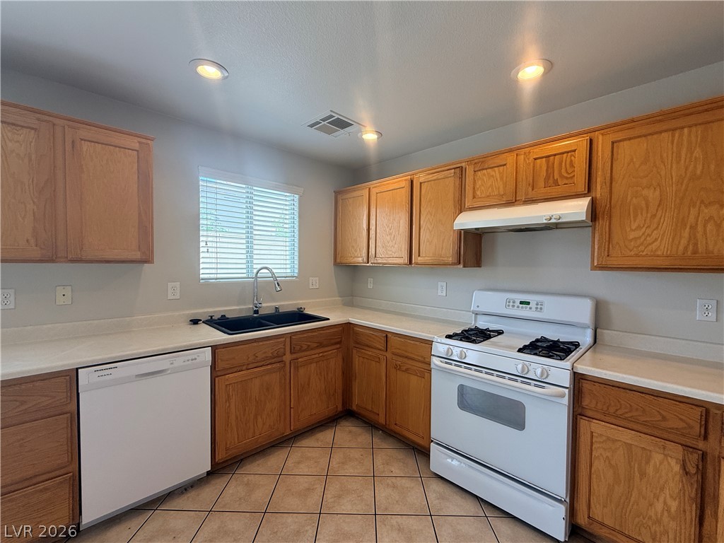 11953 Fairfax Ridge Street Las Vegas, NV 89183 - Photo 7 of 32 A well-appointed kitchen features ample cabinetry, a double basin sink, and modern appliances.
