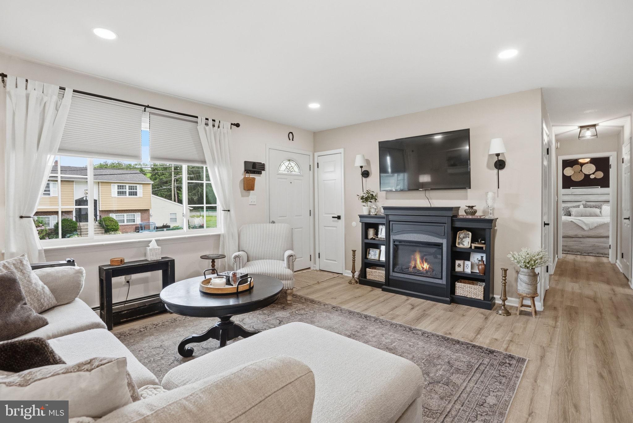 303 Radcliffe Road Glenside, PA 19038 - Photo 5 of 36 a living room with furniture a flat screen tv and a large window