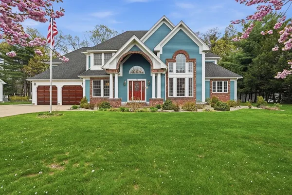 a front view of a house with a garden