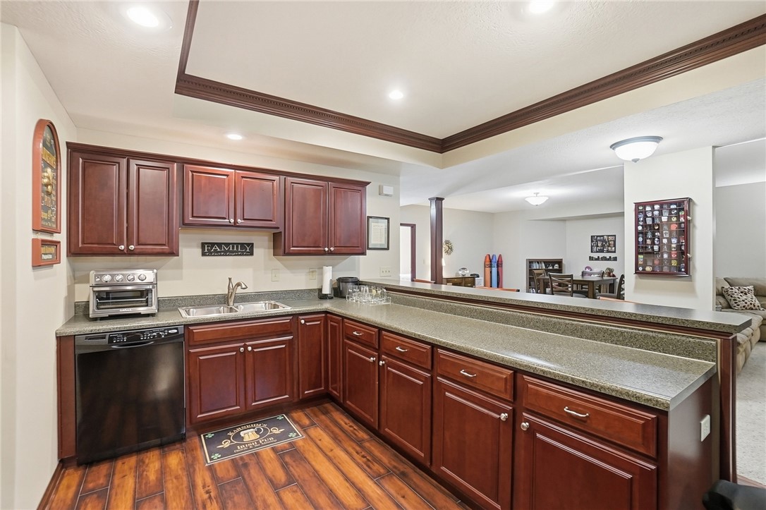 710 Governors Road Troy, OH 45373 - Photo 35 of 56 This lower-level kitchen features warm wood cabinetry and durable countertops, perfect for entertaining.