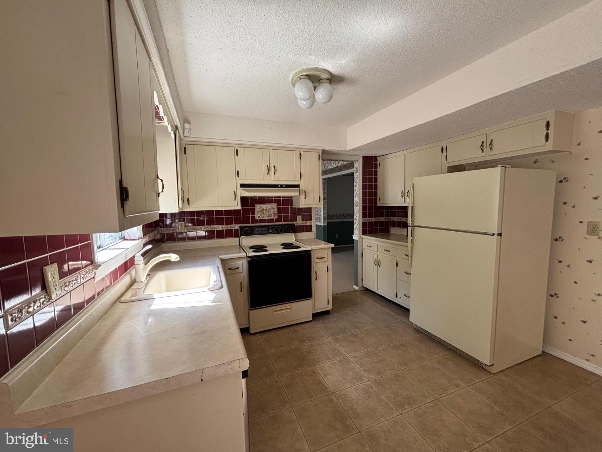 20 Bock Boulevard Howell, NJ 07731 - Photo 8 of 32 a kitchen with a refrigerator sink and stove