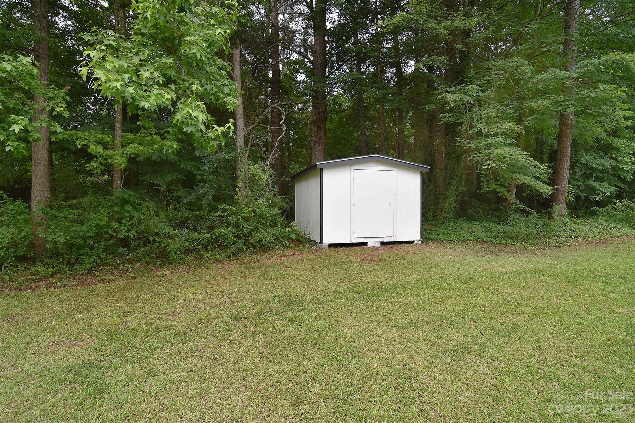 838 Culdesac Road Lancaster, SC 29720 - Photo 30 of 30 a backyard of a house with plants and large trees