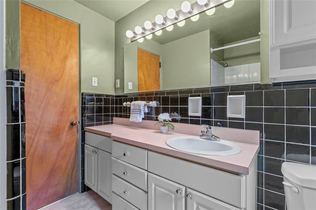 21 Ryan Drive Pittsburgh, PA 15220 - Photo 24 of 28 a bathroom with a sink and a mirror