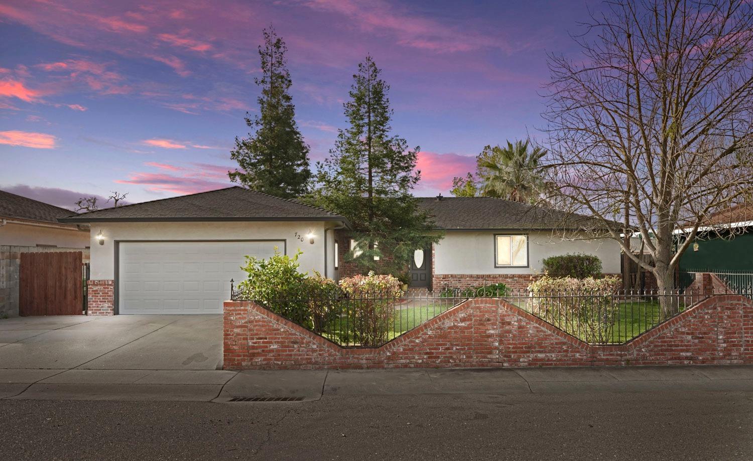720 G Street Galt, CA 95632 - Photo 1 of 1 a front view of a house with a yard and garage