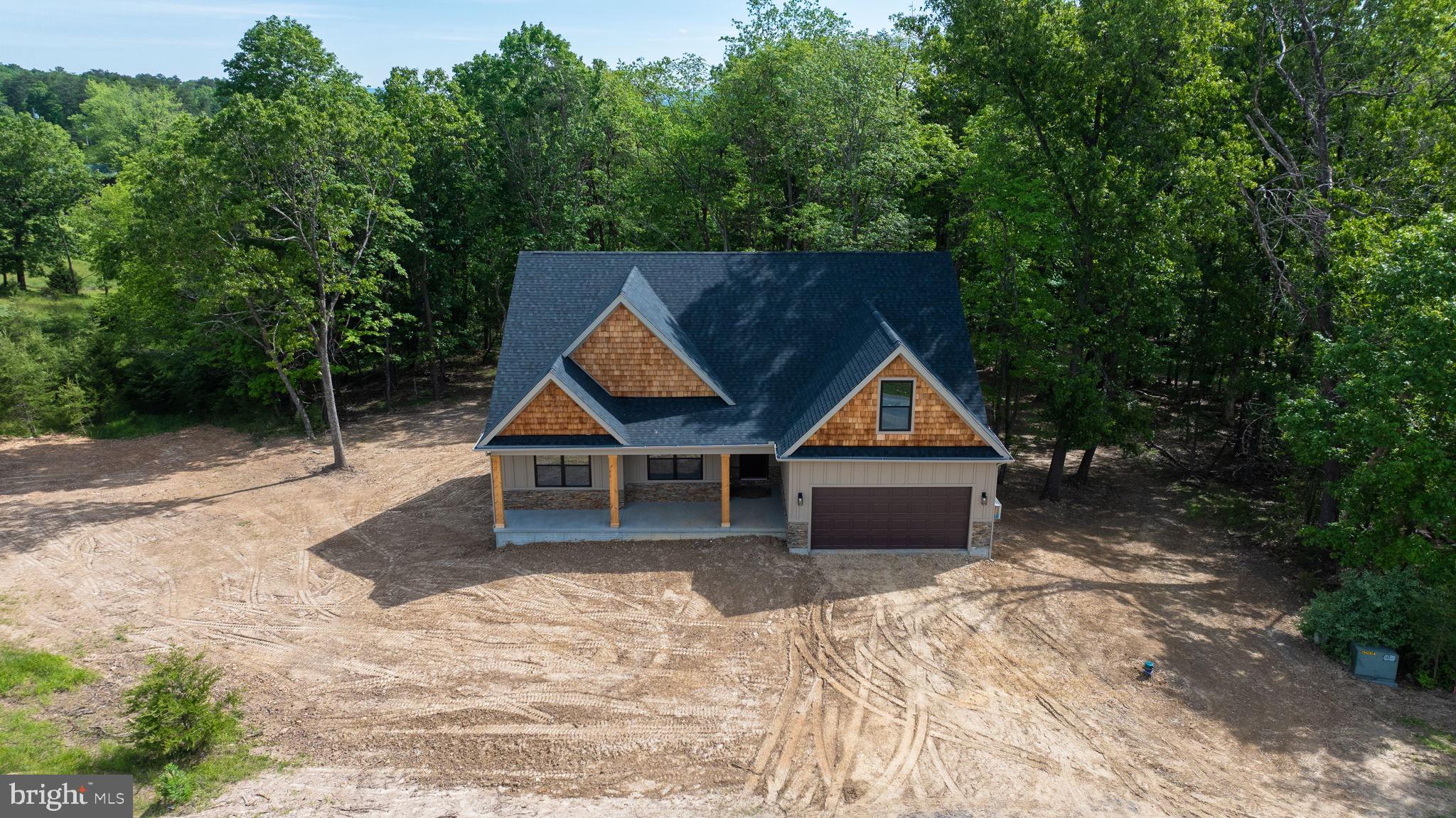 2 Libby's Ridge Road Berkeley Springs, WV 25411 - Photo 11 of 35 a house with trees in the background