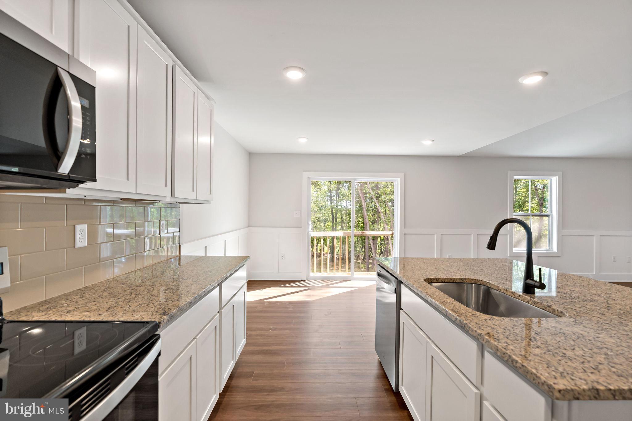 2 Libby's Ridge Road Berkeley Springs, WV 25411 - Photo 12 of 35 a kitchen with stainless steel appliances granite countertop a sink a stove and a microwave