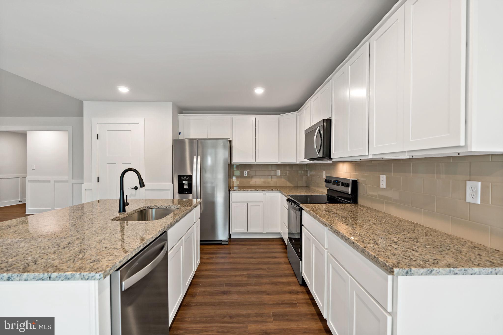 2 Libby's Ridge Road Berkeley Springs, WV 25411 - Photo 13 of 35 a kitchen with stainless steel appliances granite countertop a sink stove and refrigerator