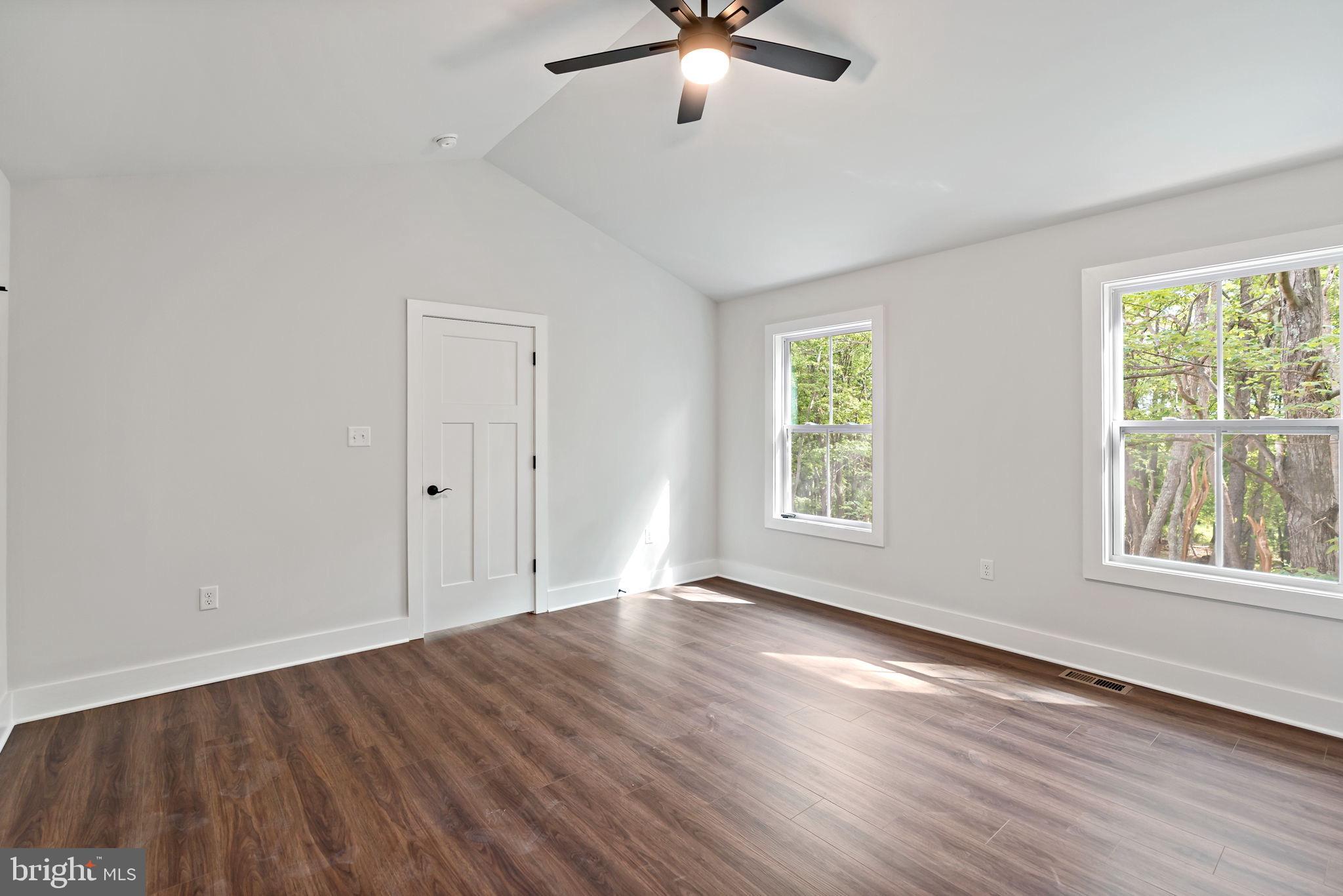 2 Libby's Ridge Road Berkeley Springs, WV 25411 - Photo 18 of 35 a view of an empty room with wooden floor and a window