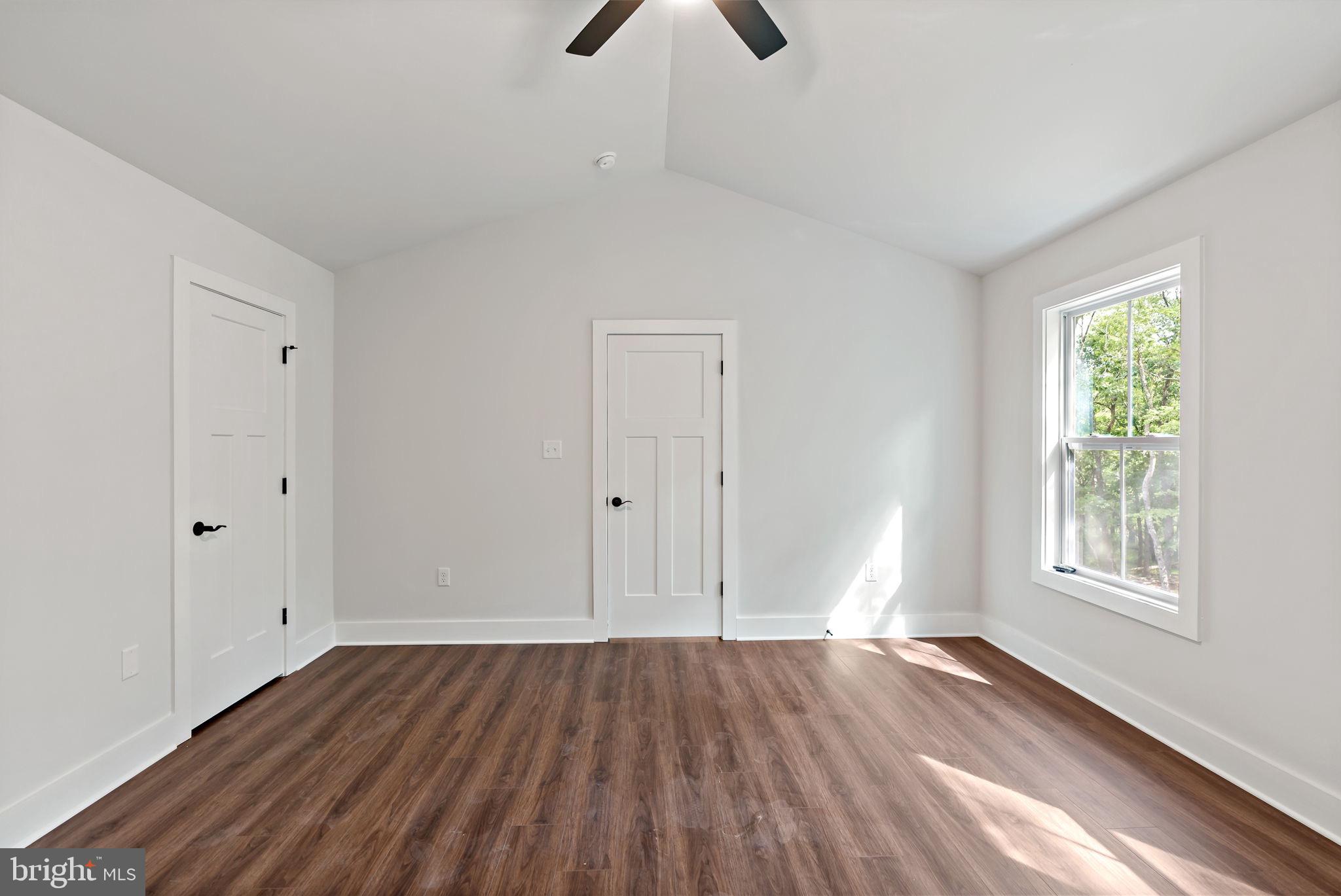 2 Libby's Ridge Road Berkeley Springs, WV 25411 - Photo 19 of 35 wooden floor in an empty room with a window