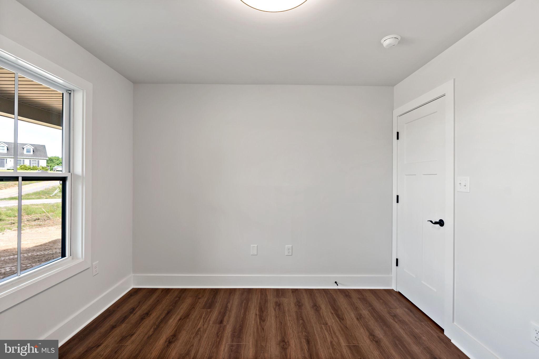 2 Libby's Ridge Road Berkeley Springs, WV 25411 - Photo 24 of 35 wooden floor in an empty room with a window
