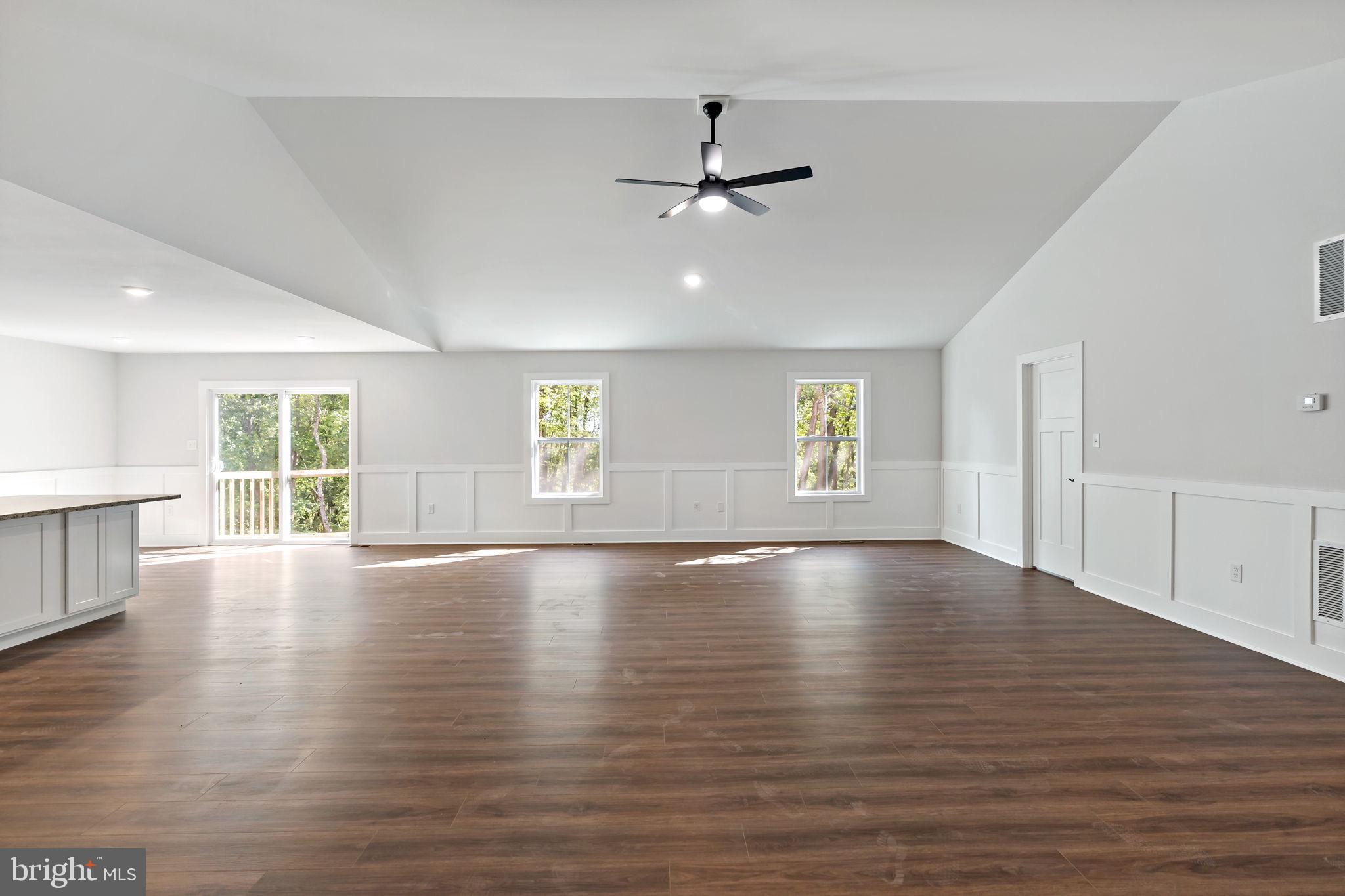 2 Libby's Ridge Road Berkeley Springs, WV 25411 - Photo 5 of 35 a view of an empty room with wooden floor and a window