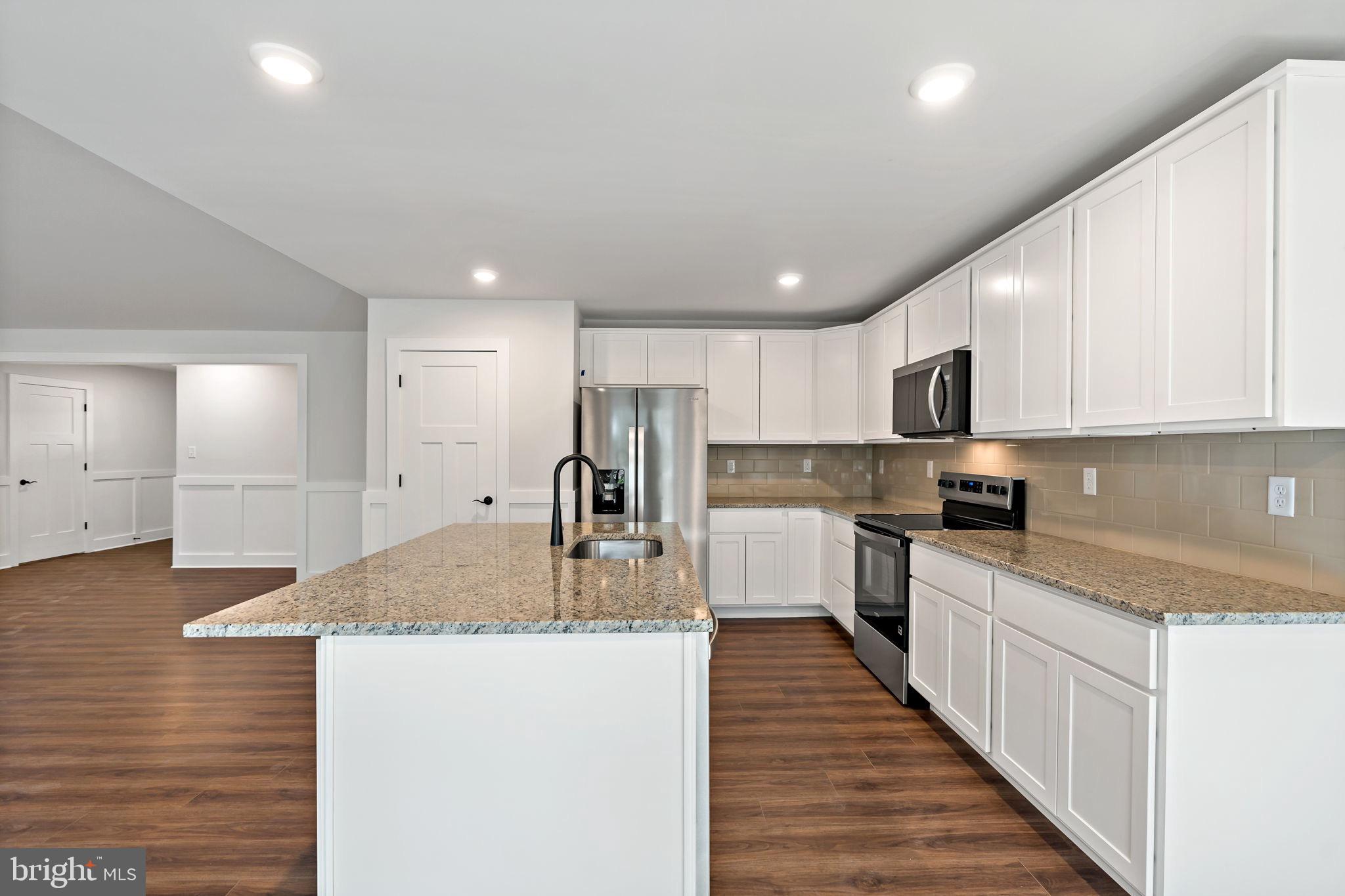 2 Libby's Ridge Road Berkeley Springs, WV 25411 - Photo 9 of 35 a kitchen with stainless steel appliances granite countertop a sink and cabinets