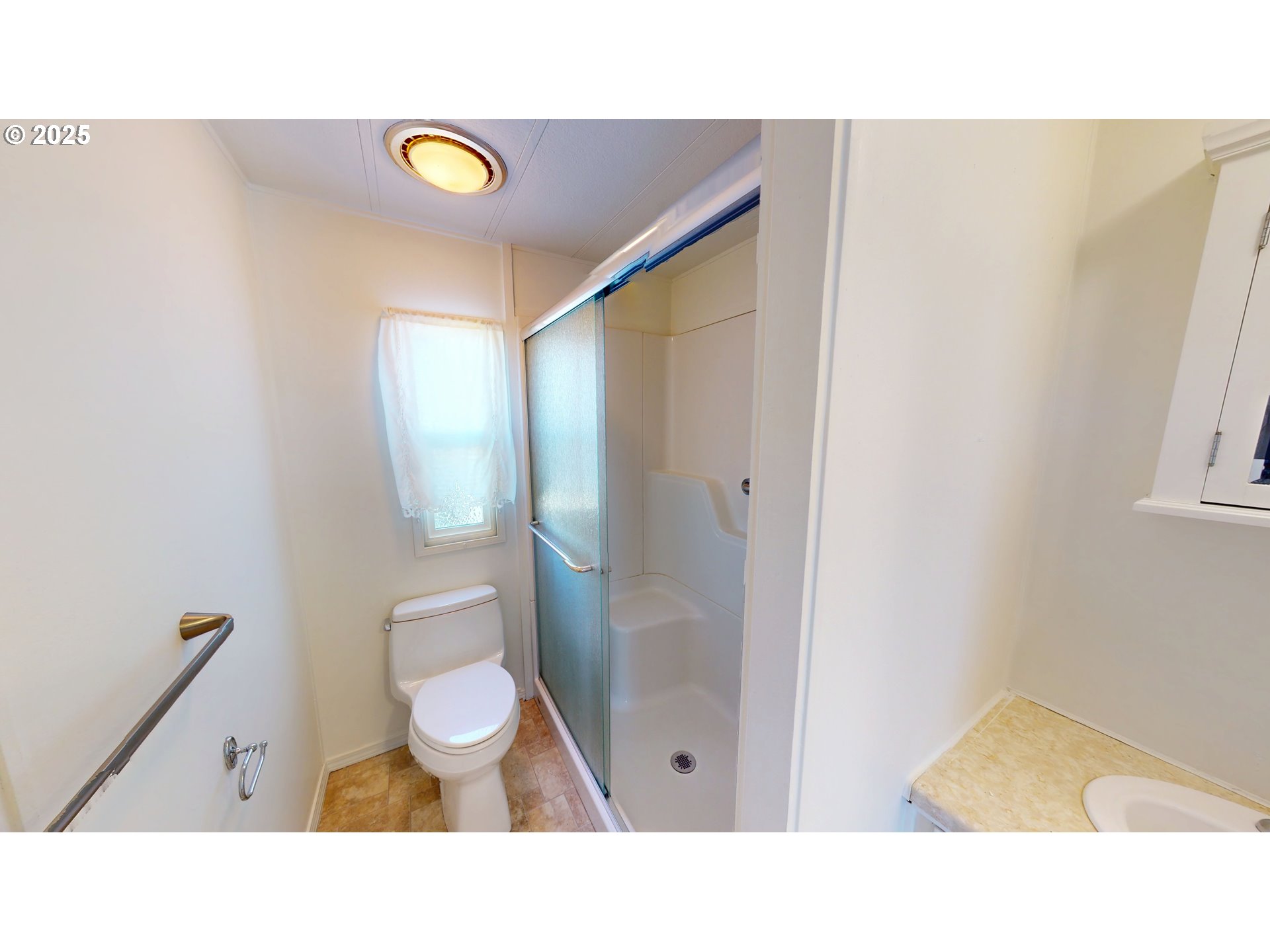 15889 Sunset Strip, Unit 102 Brookings, OR 97415 - Photo 20 of 27 a bathroom with a toilet a sink and mirror