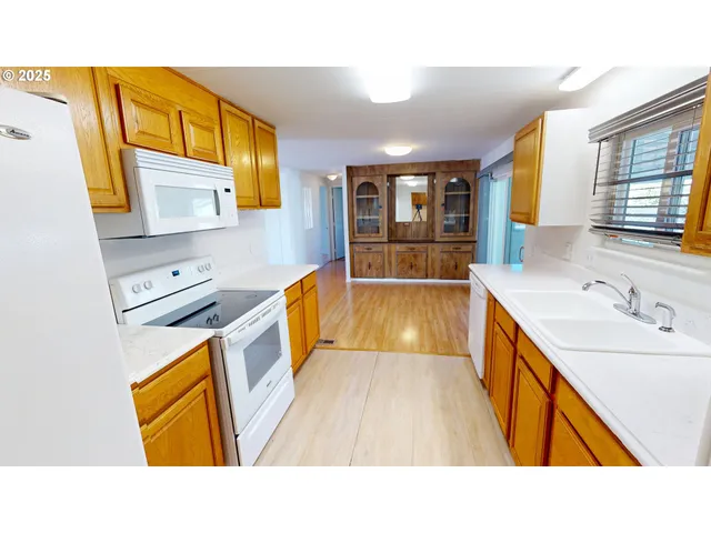 a bathroom with a sink a bathtub a mirror a vanity and a sink