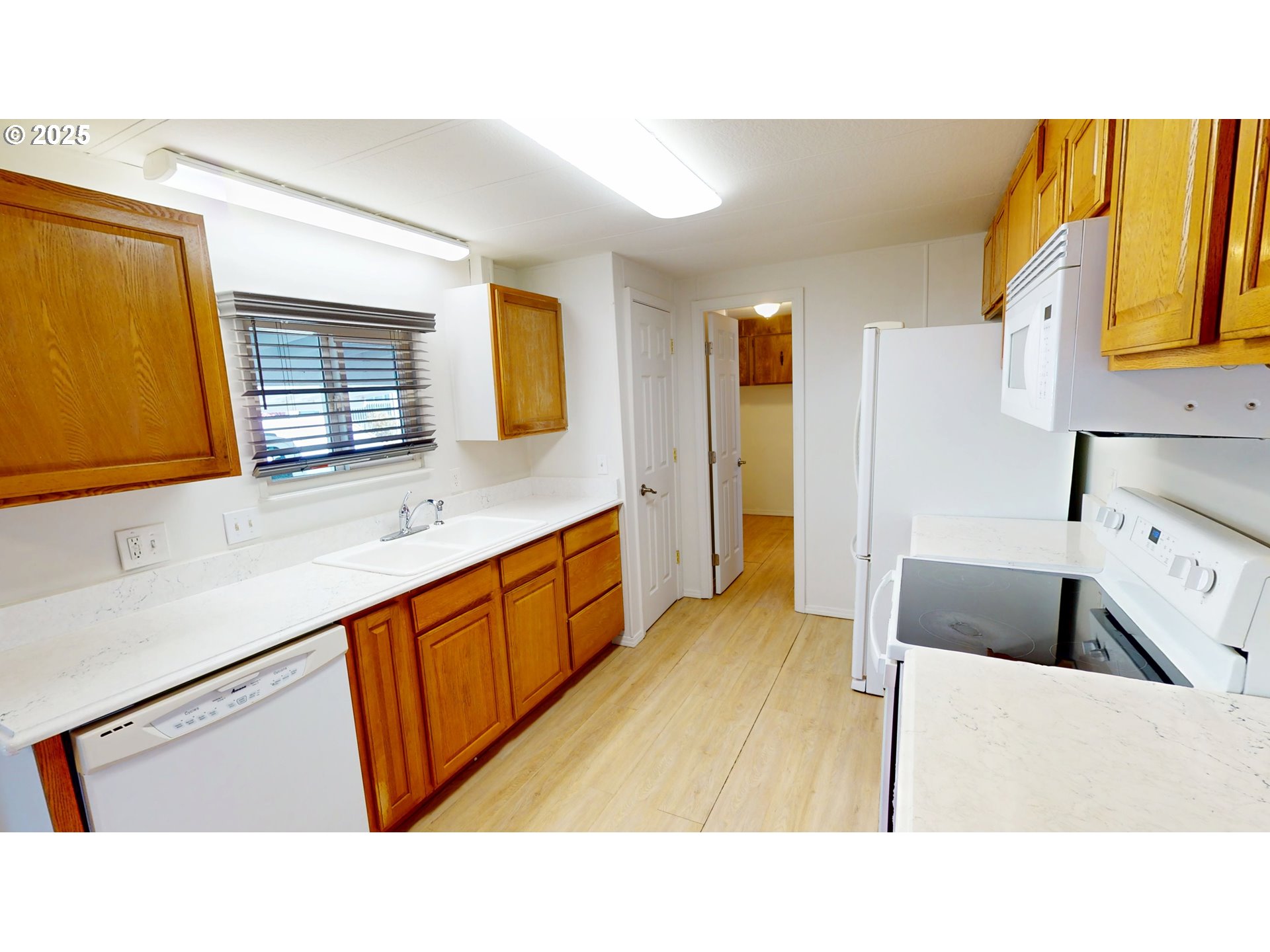 15889 Sunset Strip, Unit 102 Brookings, OR 97415 - Photo 8 of 27 a bathroom with a sink a mirror and a bathtub