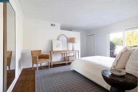 a bedroom with a bed and chair