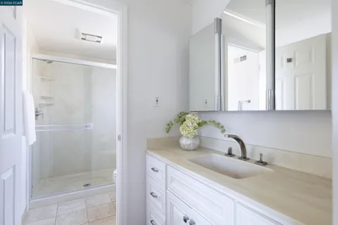 a bathroom with a granite countertop sink and a mirror