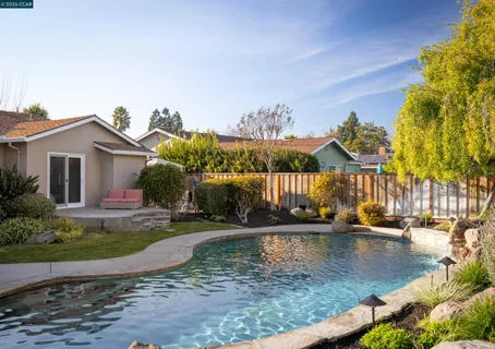 a view of a swimming pool with a patio