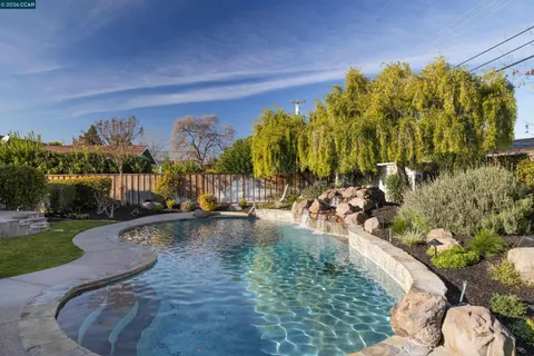 a view of swimming pool in front of house