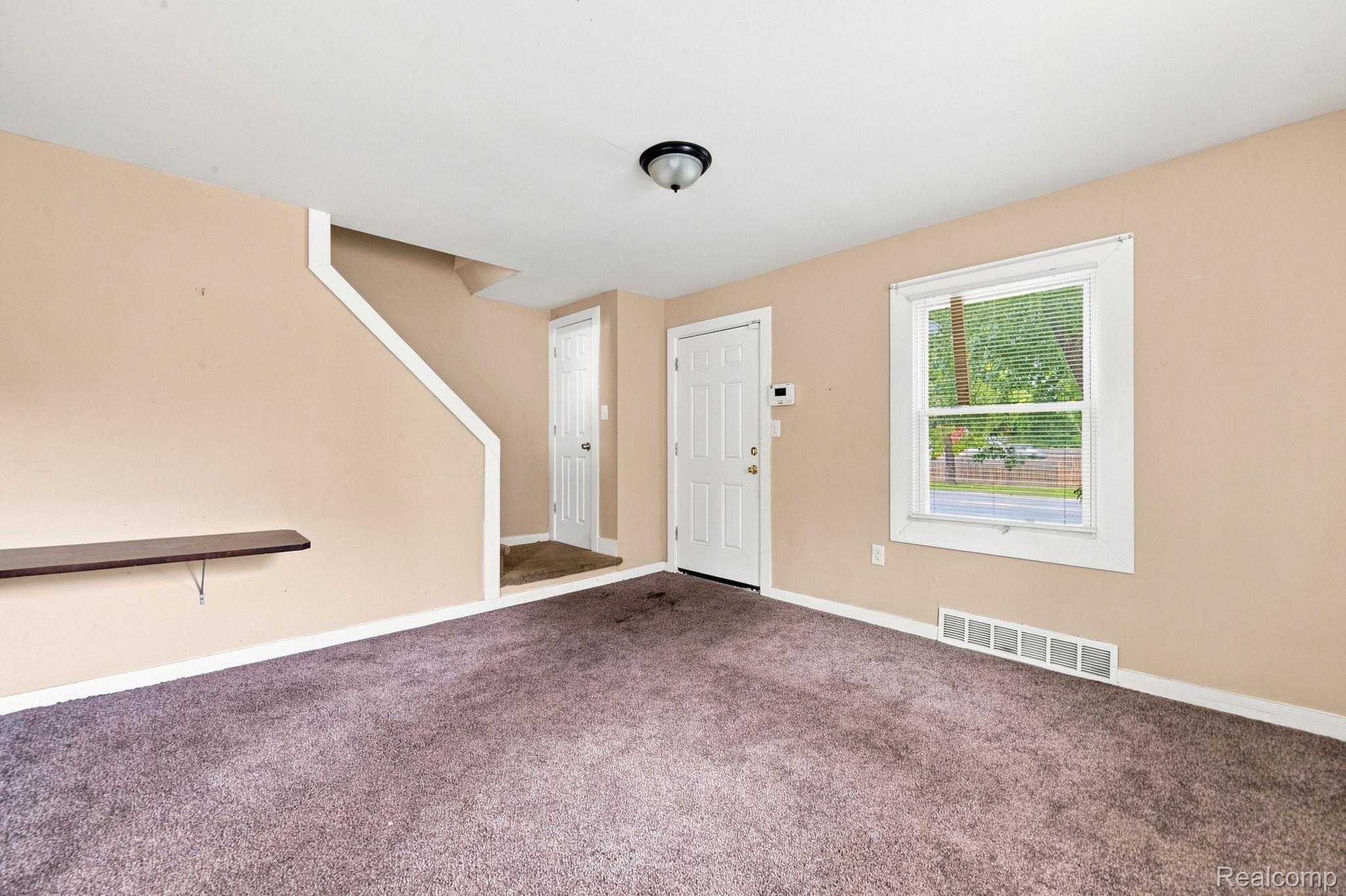 8882 Evergreen Road Detroit, MI 48228 - Photo 7 of 21 Neutral-toned walls, carpeted flooring, and a white window frame