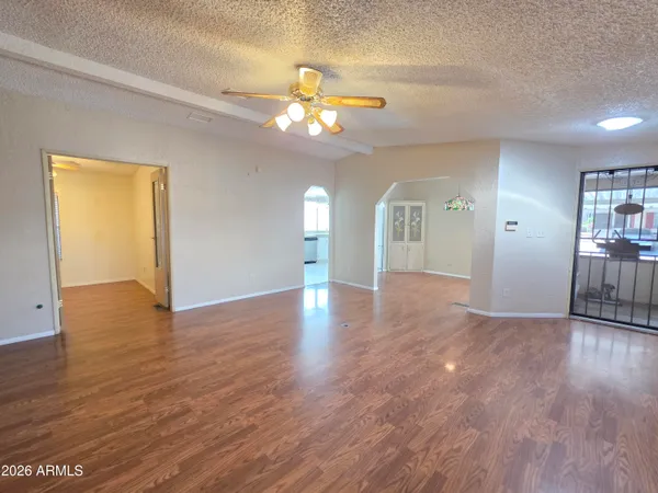 an empty room with wooden floor and closet