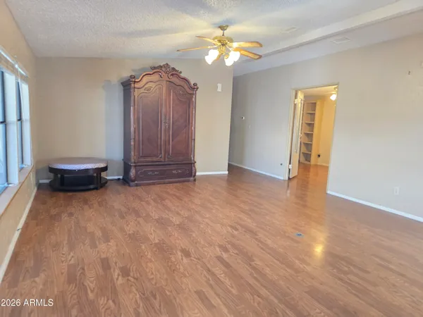 a view of a room with an empty space and wooden floor