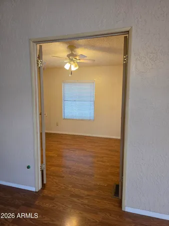 wooden floor in an empty room with a window