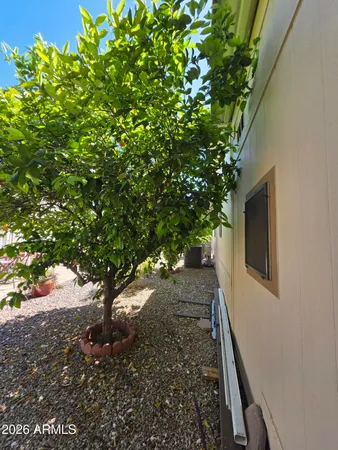 a view of a patio with table and chairs with wooden floor and fence