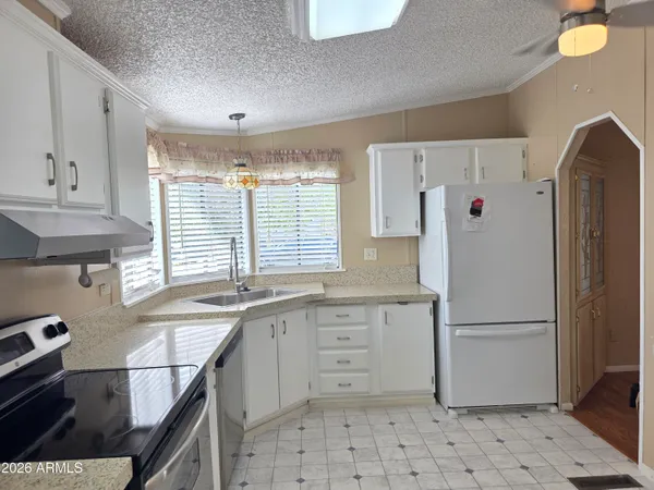 a kitchen with cabinets appliances and a window
